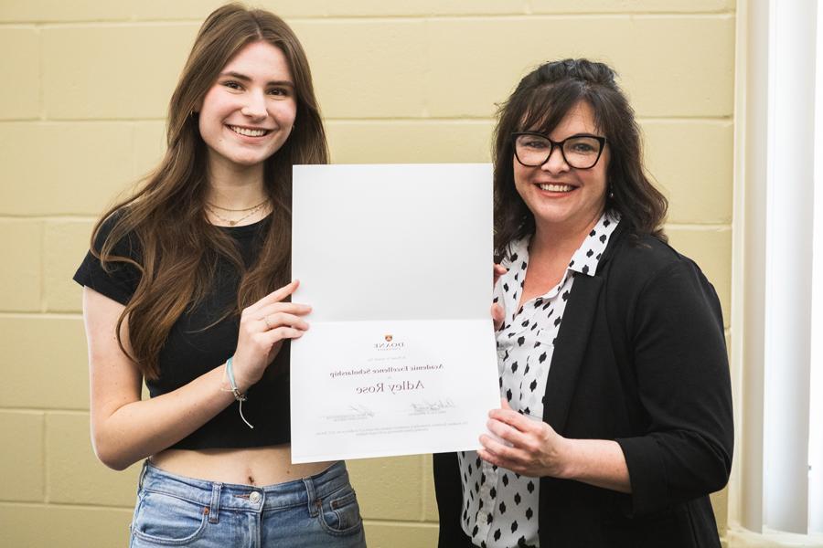 Adley Rose (right) holds up her Academic Excellence Scholarship award certificate with Jessica Pulte, Doane recruiter who covers the Omaha metro. 