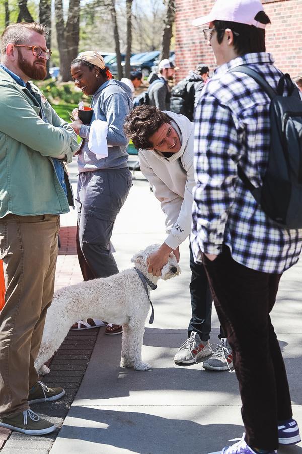 Georgie gets a head pat from students at the Academic Success Center's booth outside of Perry Campus Center during DeStress Fest in the week before finals.