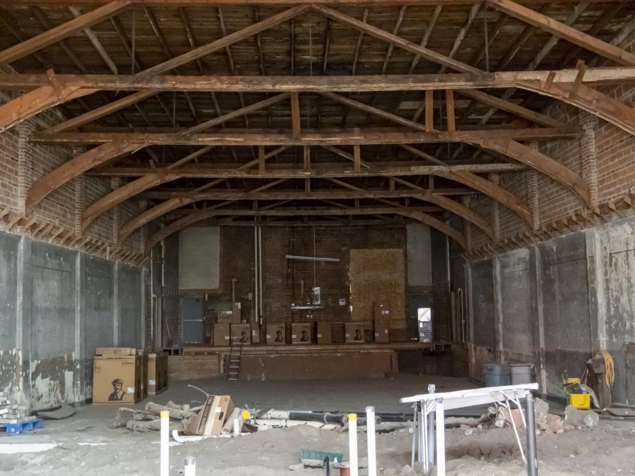 克里特岛伊希斯剧院的内部图像, 内布拉斯加州, 哪个目前正在翻修. The arched ceiling beams are exposed 和 walls are down to studs 和 brickwork, 但很明显它仍然是一个剧院, 在大楼的尽头有一个舞台. 