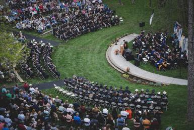 An aerial view of Cassel Theatre filled with graduates and their families for spring commencement.